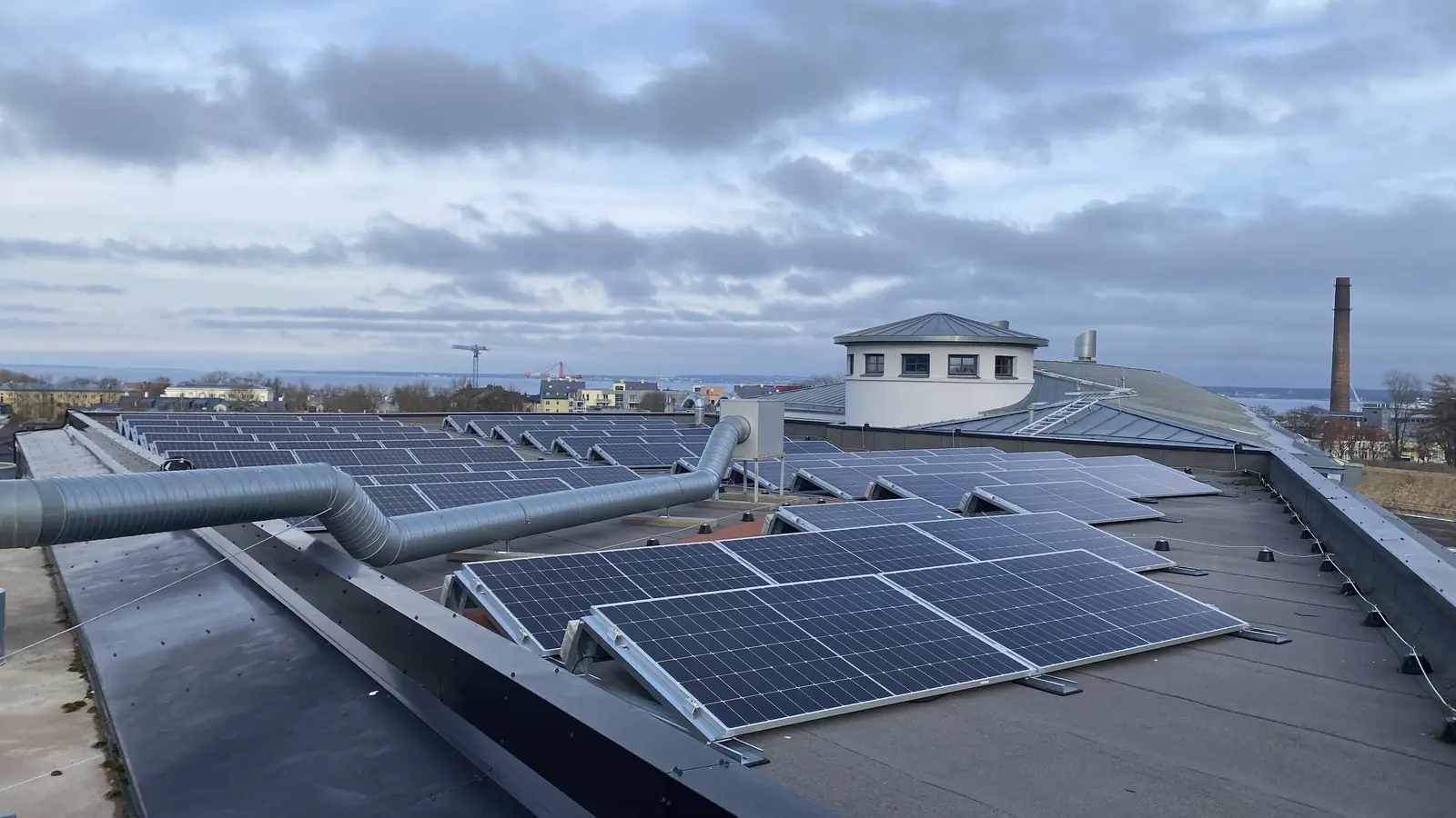 Solar array laid out across a large flat commercial roof