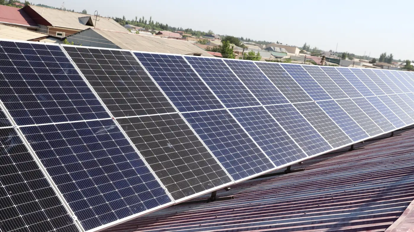 A row of solar panels mounted on rails across a residential roof